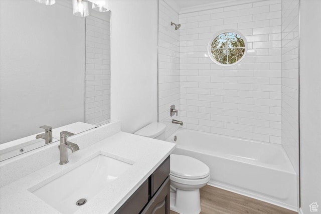 full bathroom featuring shower / tub combination, wood finished floors, toilet, and vanity