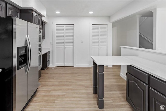 kitchen featuring stainless steel fridge with ice dispenser, light countertops, recessed lighting, and light wood finished floors