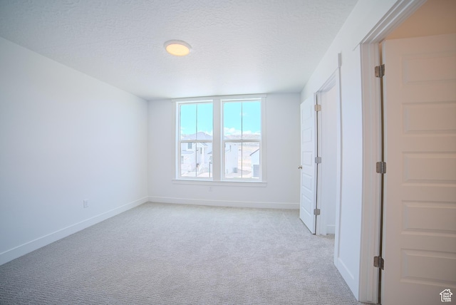 1258 S Boxelder Dr, Saratoga Springs, UT 84005 - unfurnished bedroom featuring light colored carpet, baseboards, and a textured ceiling
