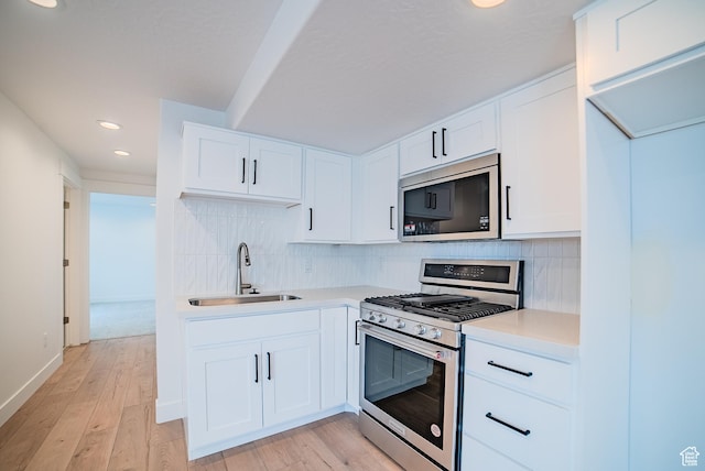 1258 S Boxelder Dr, Saratoga Springs, UT 84005 - kitchen featuring appliances with stainless steel finishes, a sink, light countertops, recessed lighting, and decorative backsplash
