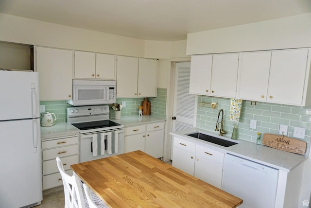 825 E 3990 S Unit C, Millcreek, UT 84107 - kitchen featuring light countertops, white appliances, a sink, and tasteful backsplash