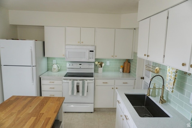 825 E 3990 S Unit C, Millcreek, UT 84107 - kitchen with backsplash, white cabinetry, a sink, and white appliances