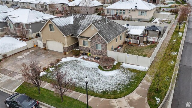 snowy aerial view with a residential view