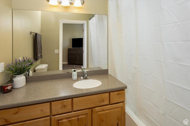 bathroom featuring toilet and vanity