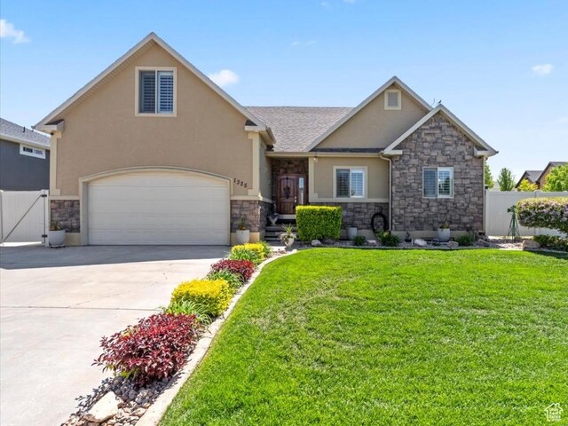 1325 W Trailside Dr, Santaquin, UT 84655 - view of front of home with stone siding, stucco siding, driveway, and a gate