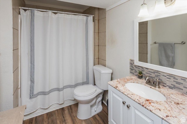 bathroom featuring decorative backsplash, a shower with shower curtain, wood finished floors, toilet, and vanity