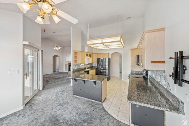 3546 Windmill Dr, Santa Clara, UT 84765 - kitchen with arched walkways, light brown cabinets, stainless steel appliances, and a ceiling fan