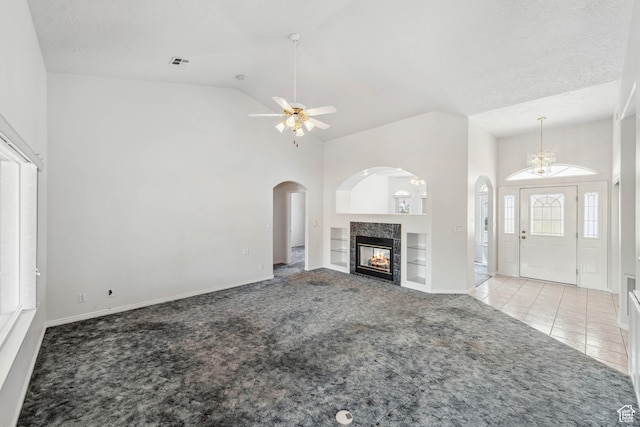 3546 Windmill Dr, Santa Clara, UT 84765 - unfurnished living room featuring visible vents, a tile fireplace, carpet, built in features, and tile patterned flooring