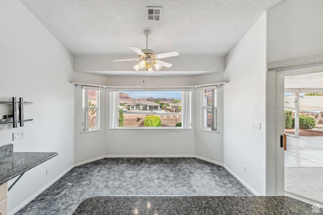 3546 Windmill Dr, Santa Clara, UT 84765 - unfurnished dining area with a ceiling fan, a textured ceiling, baseboards, visible vents, and carpet