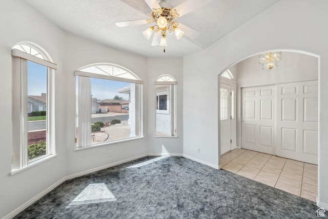 3546 Windmill Dr, Santa Clara, UT 84765 - spare room with a textured ceiling, arched walkways, carpet floors, and a healthy amount of sunlight
