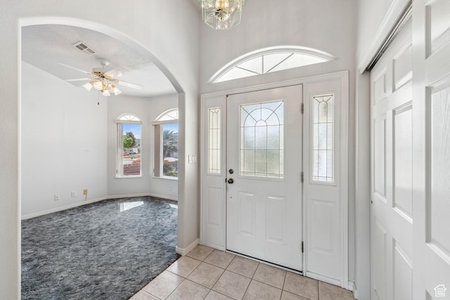 3546 Windmill Dr, Santa Clara, UT 84765 - entryway featuring visible vents, a ceiling fan, light carpet, arched walkways, and light tile patterned floors