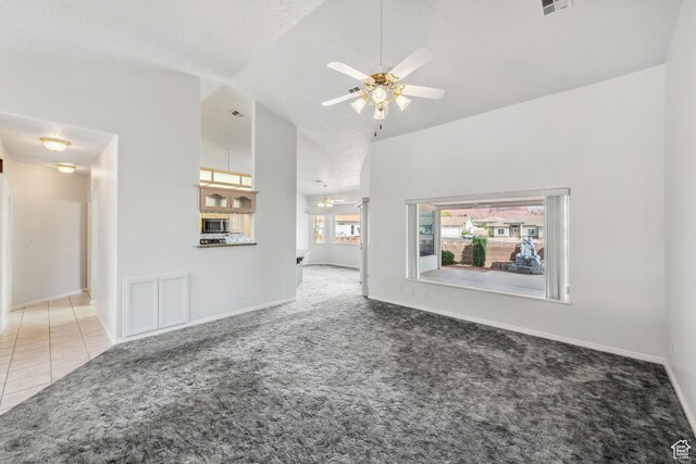 3546 Windmill Dr, Santa Clara, UT 84765 - unfurnished living room with carpet flooring, a ceiling fan, tile patterned flooring, and vaulted ceiling