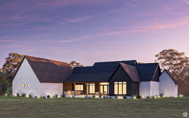 view of front of house with a front lawn, covered porch, and board and batten siding