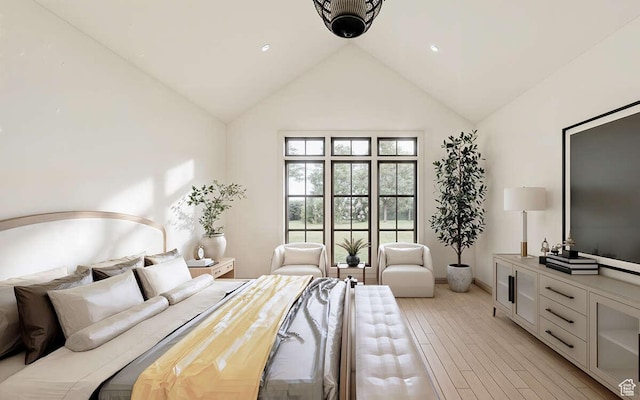bedroom featuring baseboards, high vaulted ceiling, and light wood-style flooring
