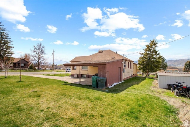 back of property featuring a yard and a patio area