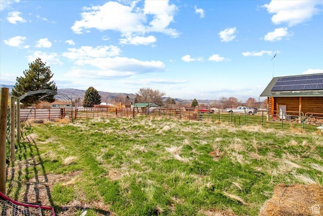 view of yard with a mountain view and a rural view