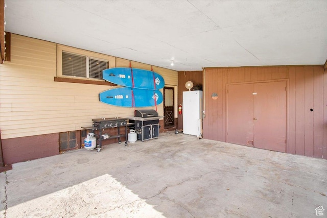 garage featuring wooden walls