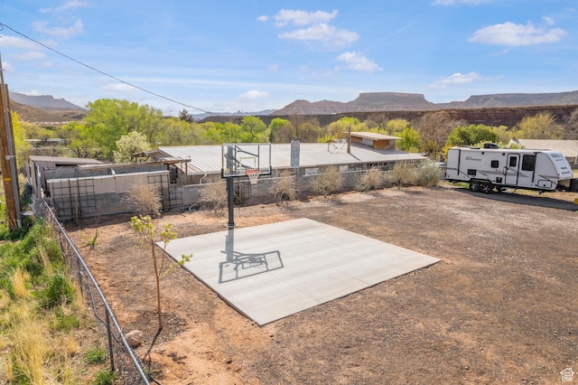 view of patio featuring a mountain view and fence