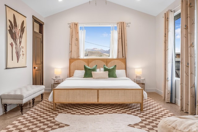 bedroom with baseboards and lofted ceiling