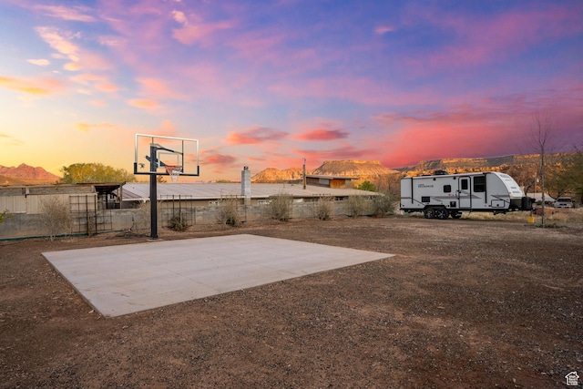 view of basketball court with basketball court and fence