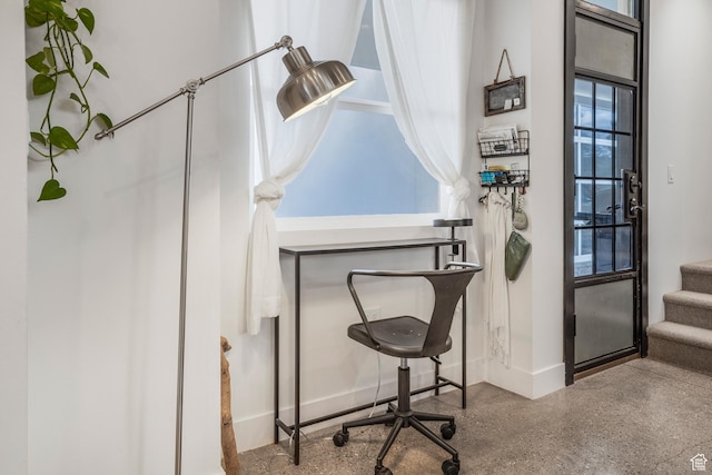 office space featuring baseboards and speckled floor
