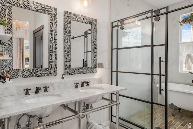 bathroom featuring a sink, a chandelier, a soaking tub, and a shower with door