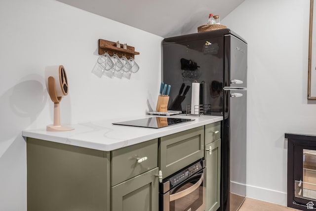kitchen featuring green cabinets, black electric cooktop, beverage cooler, and wall oven