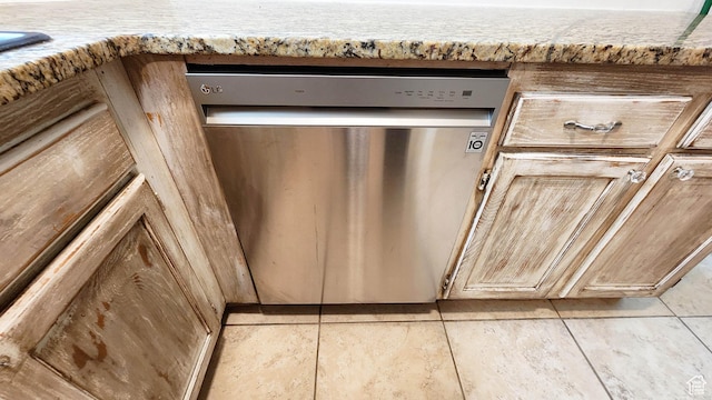 room details with light countertops and stainless steel dishwasher