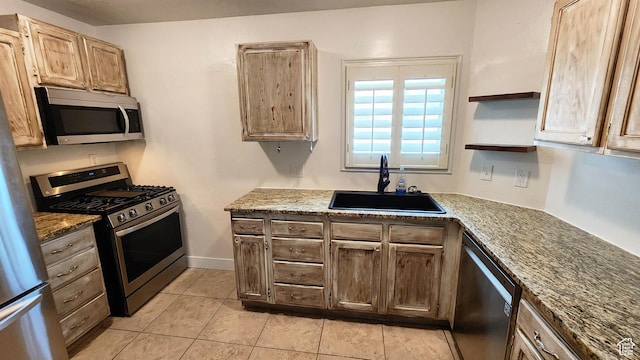 kitchen with open shelves, stainless steel appliances, light tile patterned flooring, stone counters, and a sink