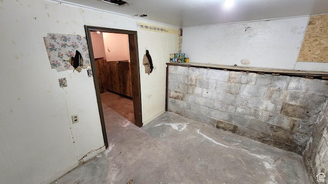 interior space with concrete block wall