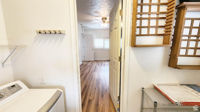 washroom featuring a ceiling fan, wood finished floors, a textured ceiling, washer / clothes dryer, and laundry area