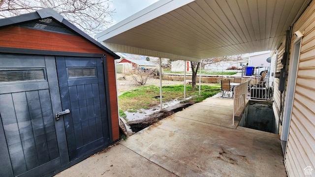 view of patio with central air condition unit, a storage unit, and an outdoor structure
