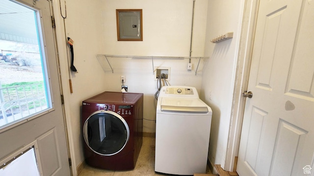 laundry room featuring washing machine and clothes dryer, plenty of natural light, laundry area, and electric panel