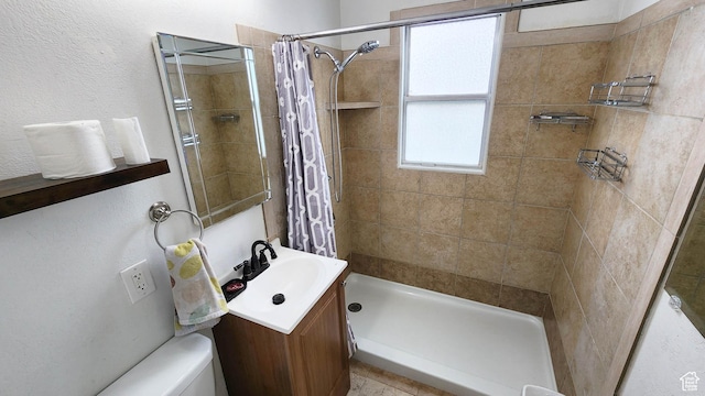 full bath featuring a tile shower, toilet, and vanity