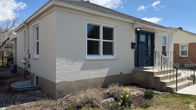 view of front of house featuring brick siding and central air condition unit