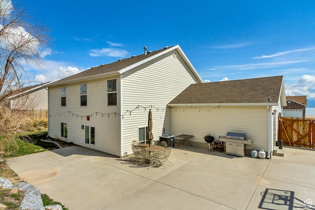 4103 S Sunrise Dr, Saratoga Springs, UT 84045 - back of property with central air condition unit, fence, a patio area, and roof with shingles