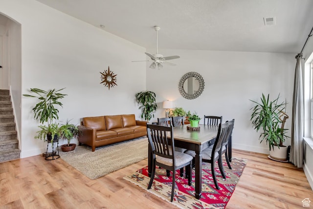 4103 S Sunrise Dr, Saratoga Springs, UT 84045 - dining space with stairs, a ceiling fan, arched walkways, visible vents, and light wood-style floors