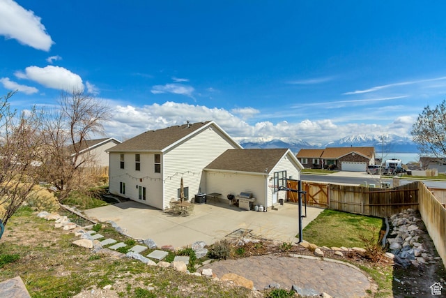 4103 S Sunrise Dr, Saratoga Springs, UT 84045 - back of property featuring fence, a gate, and a patio