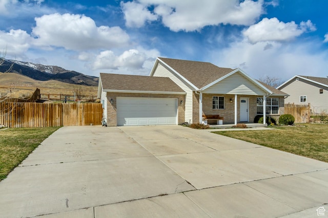 4103 S Sunrise Dr, Saratoga Springs, UT 84045 - ranch-style house featuring fence, driveway, a front yard, a mountain view, and a garage