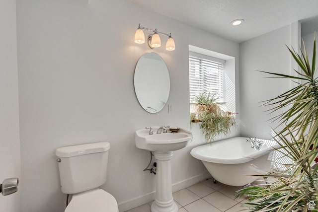 4103 S Sunrise Dr, Saratoga Springs, UT 84045 - bathroom featuring baseboards, toilet, a freestanding tub, and tile patterned floors