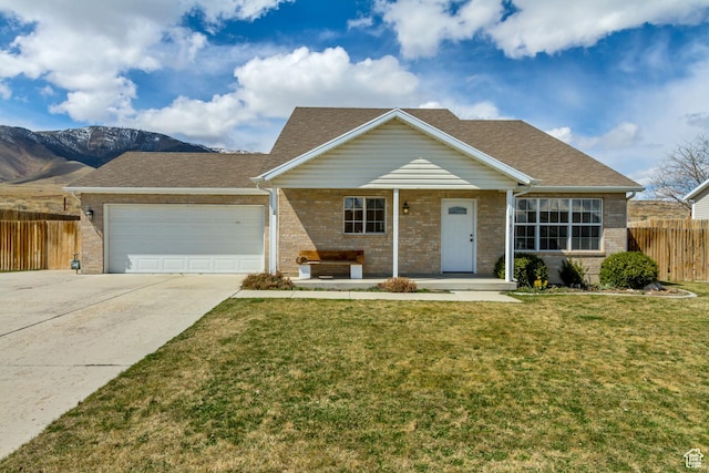single story home featuring driveway, fence, an attached garage, brick siding, and a front lawn