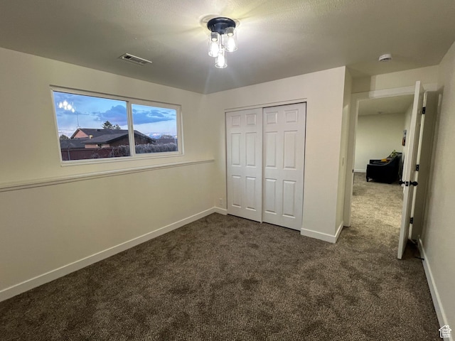 6770 W 3860 S, West Valley City, UT 84128 - unfurnished bedroom with baseboards, visible vents, a closet, and dark colored carpet