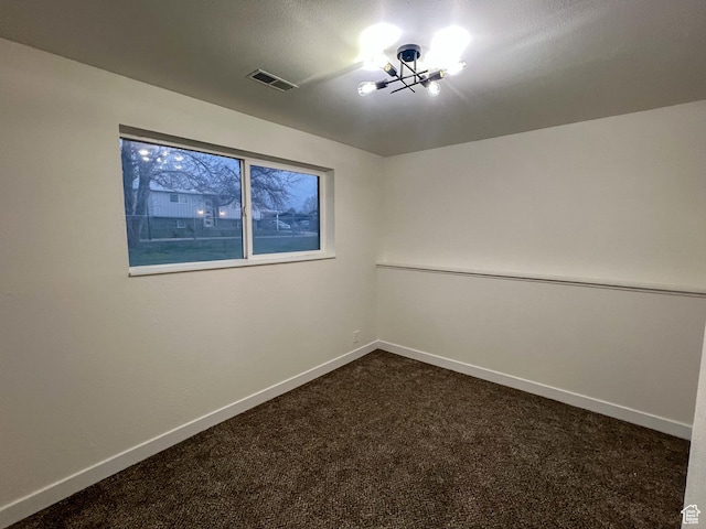 6770 W 3860 S, West Valley City, UT 84128 - spare room featuring baseboards, visible vents, dark colored carpet, and a chandelier