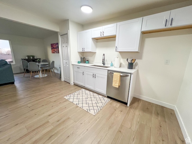 6770 W 3860 S, West Valley City, UT 84128 - kitchen with light countertops, dishwasher, white cabinetry, a sink, and light wood-style floors