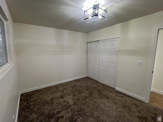 6770 W 3860 S, West Valley City, UT 84128 - unfurnished bedroom with baseboards, a notable chandelier, a closet, and carpet