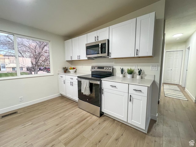 6770 W 3860 S, West Valley City, UT 84128 - kitchen with visible vents, light countertops, light wood-style flooring, and stainless steel appliances