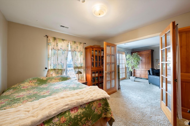 bedroom with french doors, light colored carpet, and visible vents