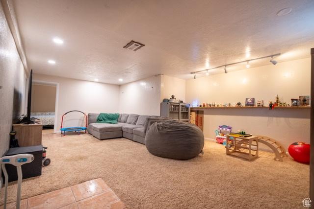 3839 S 2050 W, Roy, UT 84067 - tiled living area with carpet, recessed lighting, and rail lighting