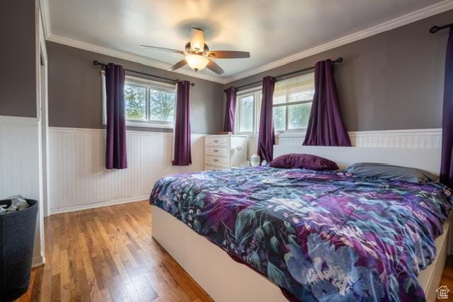 3839 S 2050 W, Roy, UT 84067 - bedroom with a wainscoted wall, wood finished floors, crown molding, and a ceiling fan