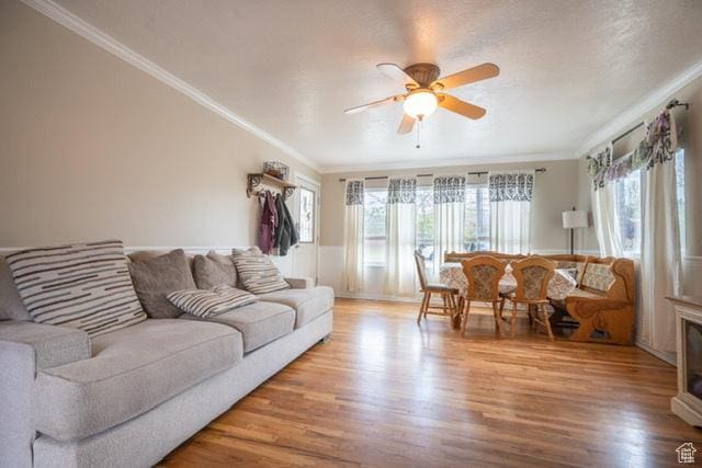 3839 S 2050 W, Roy, UT 84067 - living room featuring ornamental molding, a ceiling fan, wood finished floors, and a wainscoted wall